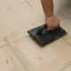 applying grout for natural stone tiles with a trowel
