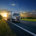a truck with road transport adhesives and sealants driving on an asfalt road away from sunset